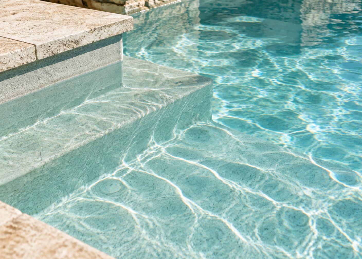Close-up of a fresh pool plaster finish in sunlight